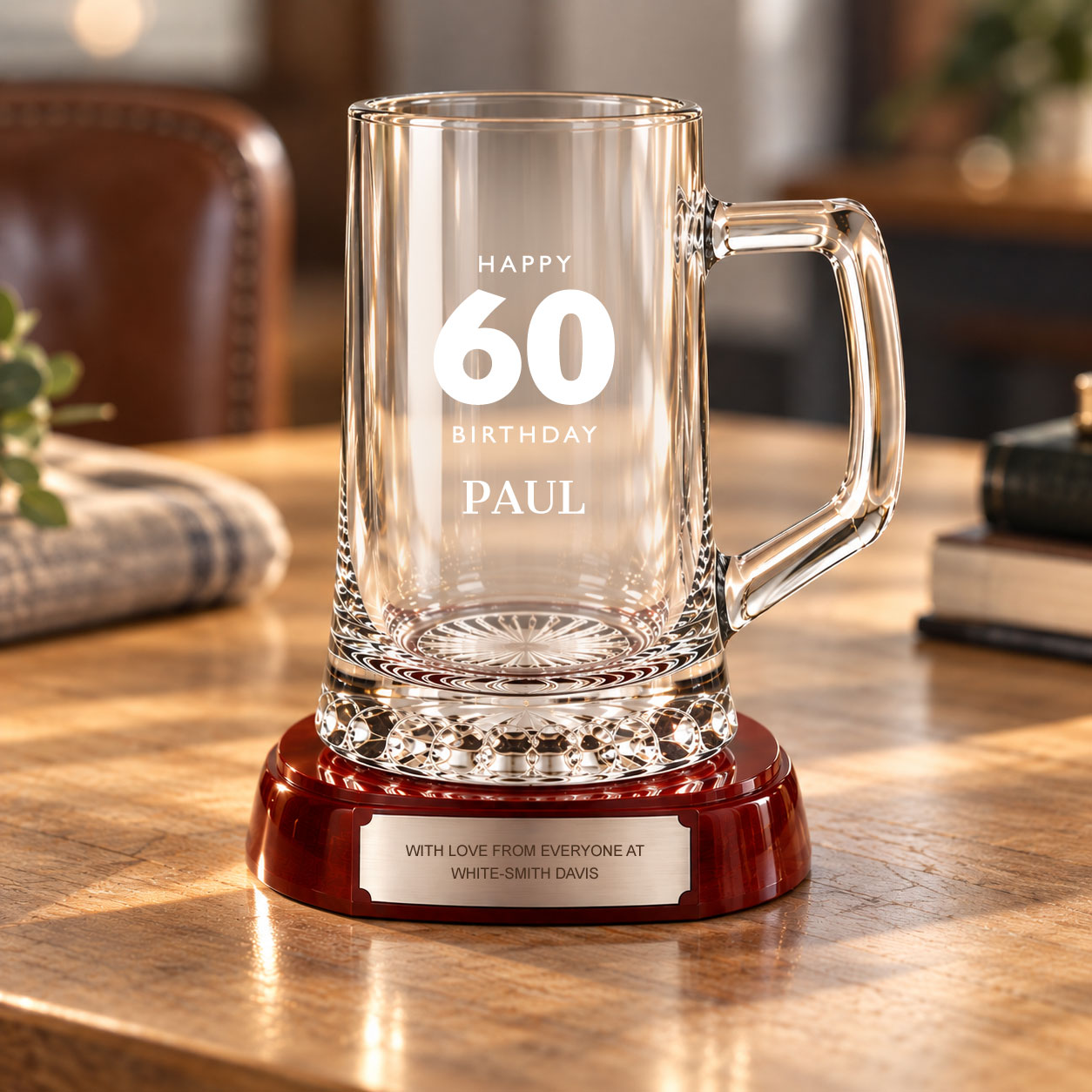 Personalised glass tankard displayed on polished wooden base with engraving plate